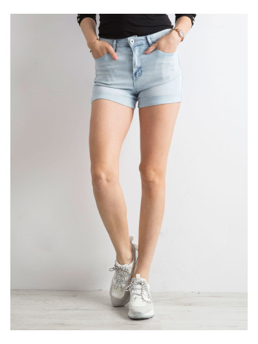 Blue denim shorts with rolled up legs