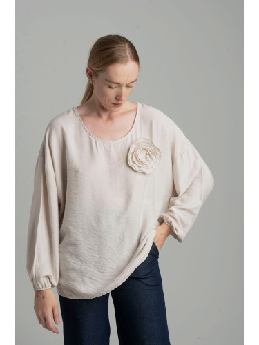 Beige oversize blouse with a decorative flower