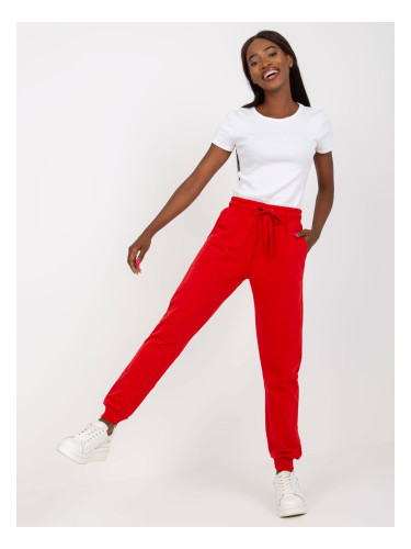 Red sweatpants tied at the waist