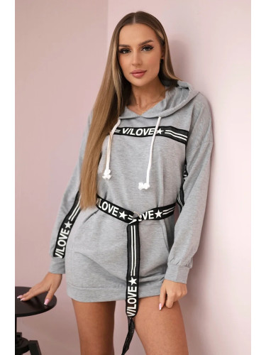 Dress decorated with a tape with gray inscriptions