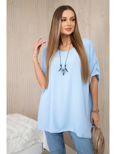 Oversized blouse with blue pendant