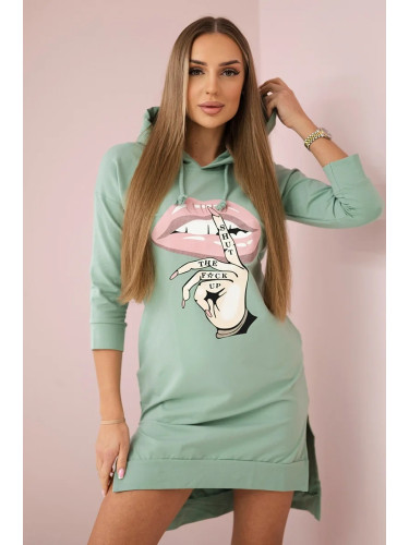 Dress with a longer back and a colorful dark mint print