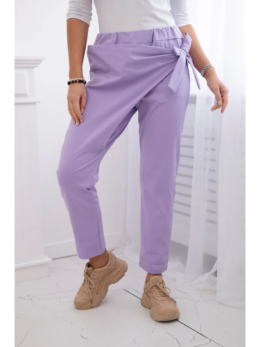 Trousers tied with an asymmetrical light purple front
