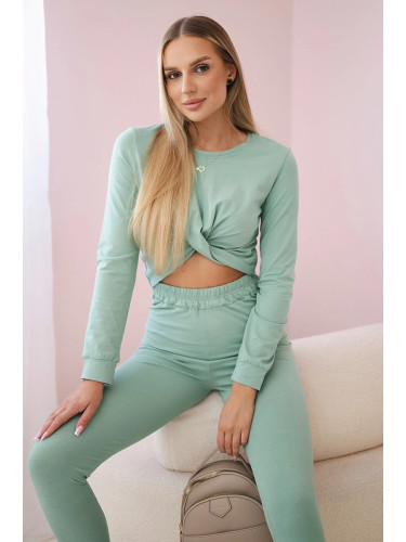 Set with frills on a dark mint blouse