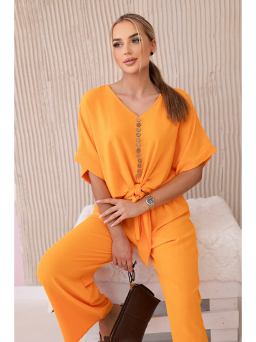 Set of bright orange blouse and trousers