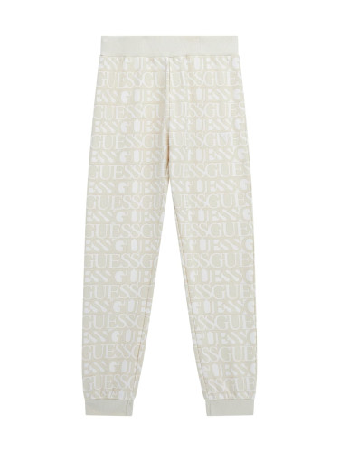 Детско спортно долнище в бежов цвят с надписи Guess