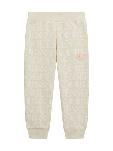 Детско спортно долнище в бежов цвят с лого и надписи Guess
