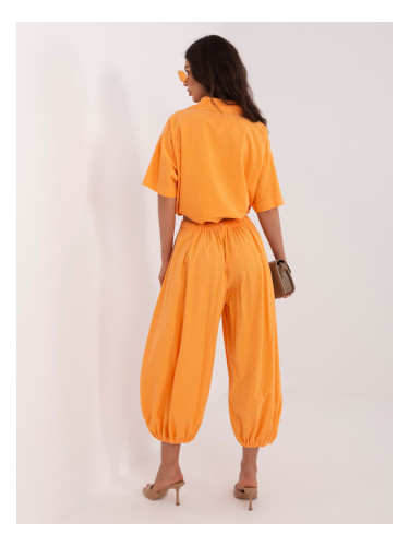 Яркооранжеви панталони с шипове