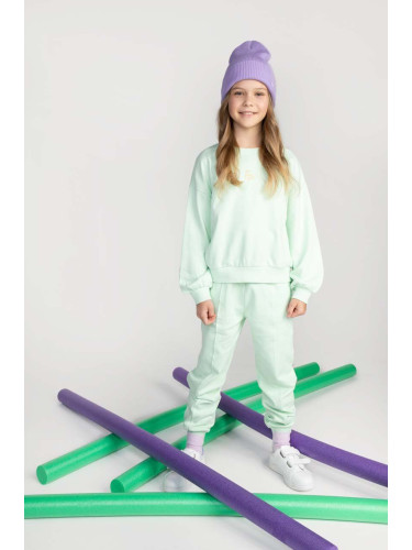 Детски памучен спортен панталон Coccodrillo в тюркоазено с изчистен дизайн