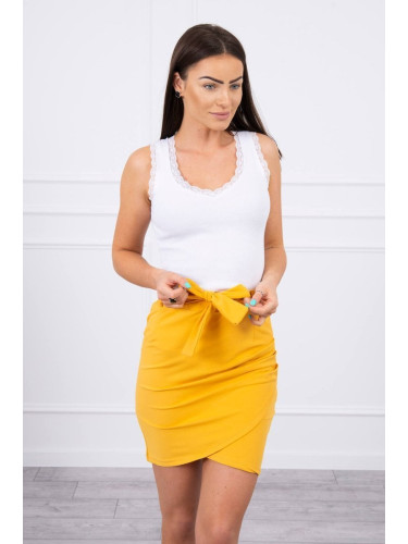 Wrap skirt tied at the waist with mustard