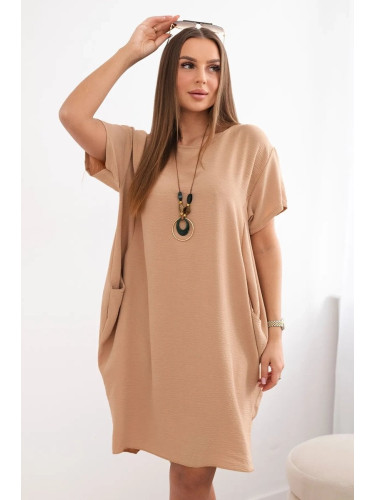 Dress with pockets and a Camel pendant
