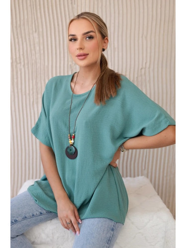Oversized blouse with a dark mint pendant