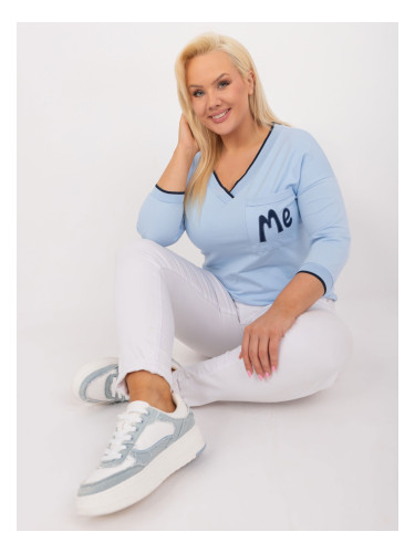 A light blue blouse in a larger size with cuffs