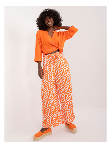 Orange wide trousers with SUBLEVEL print