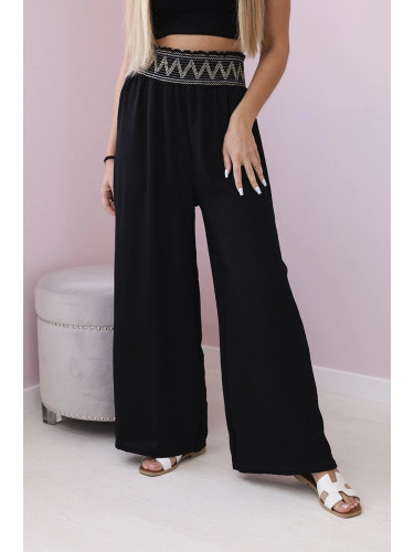 Black trousers with a wide elastic waistband