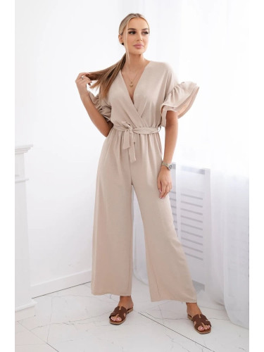 Jumpsuit with a tie at the waist with decorative sleeves in beige color