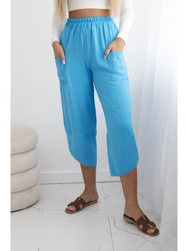 Turquoise trousers with wide legs and pockets